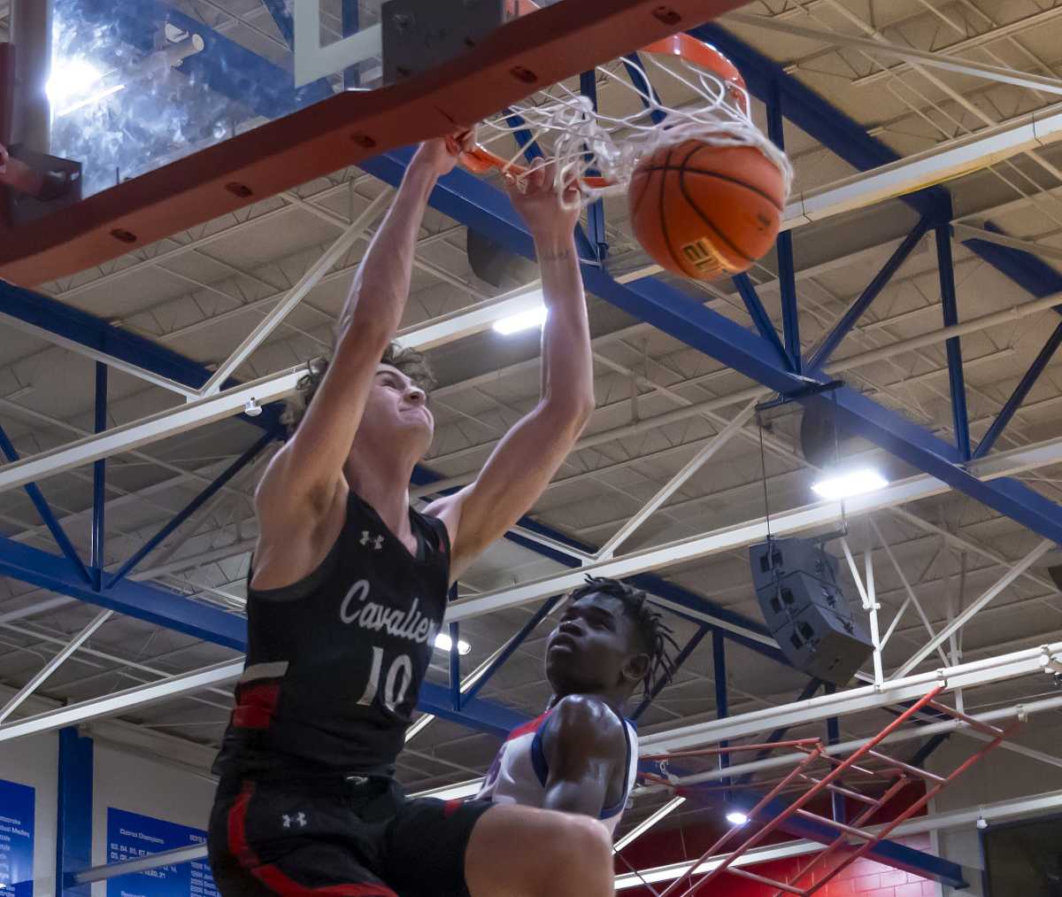 Hudson Greer, Lake Travis four-star, slam dunks around Austin Westlake center Wonder Kahozi looks on during the second quarter at a 6A District 26 game in December.
